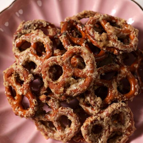 Overhead of Butter Toffee Pretzels on a pink scalloped plate