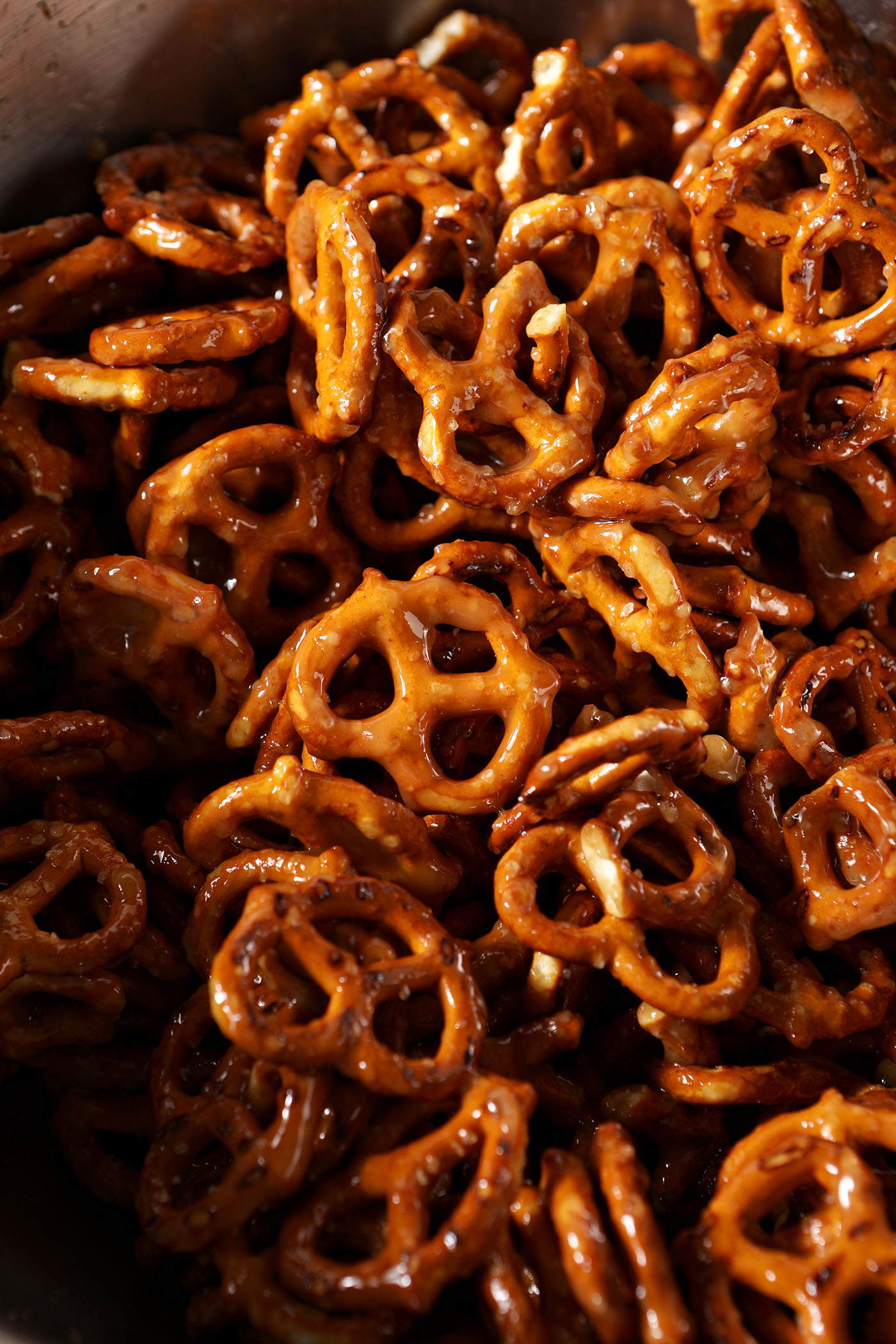 Crispy pretzels tossed in a toffee sauce in a bowl
