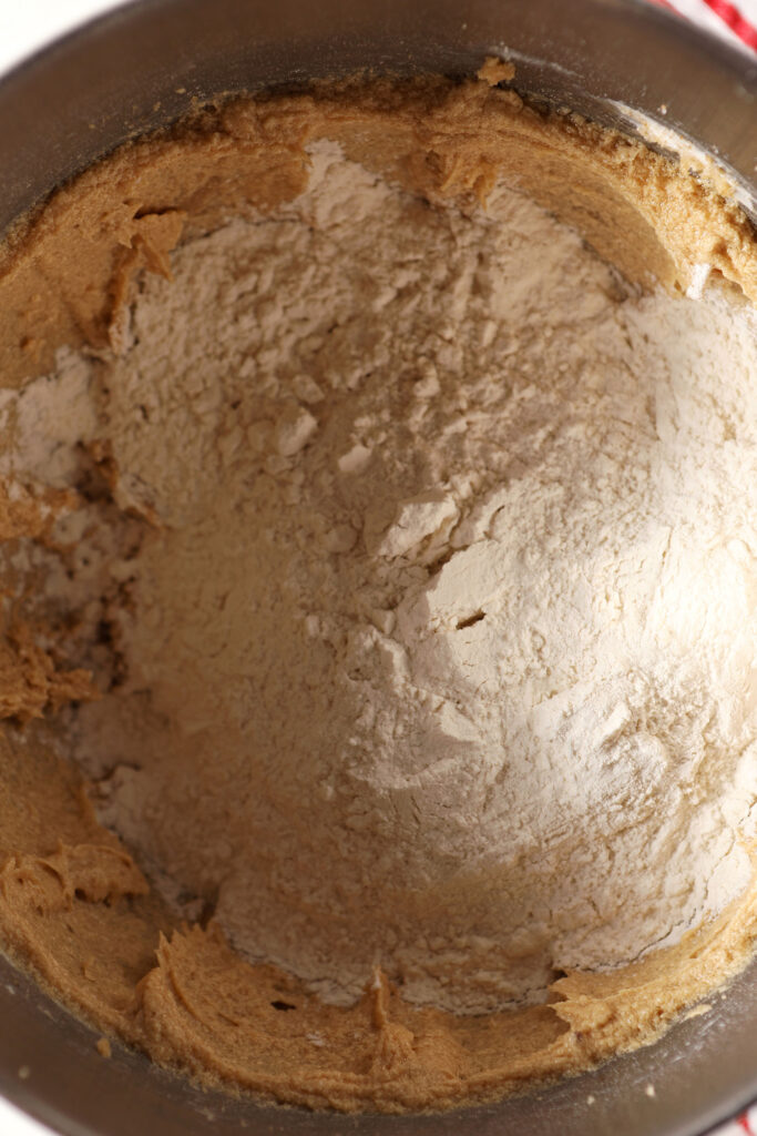 The dry ingredients sit on top of whipped wet ingredients in a metal bowl