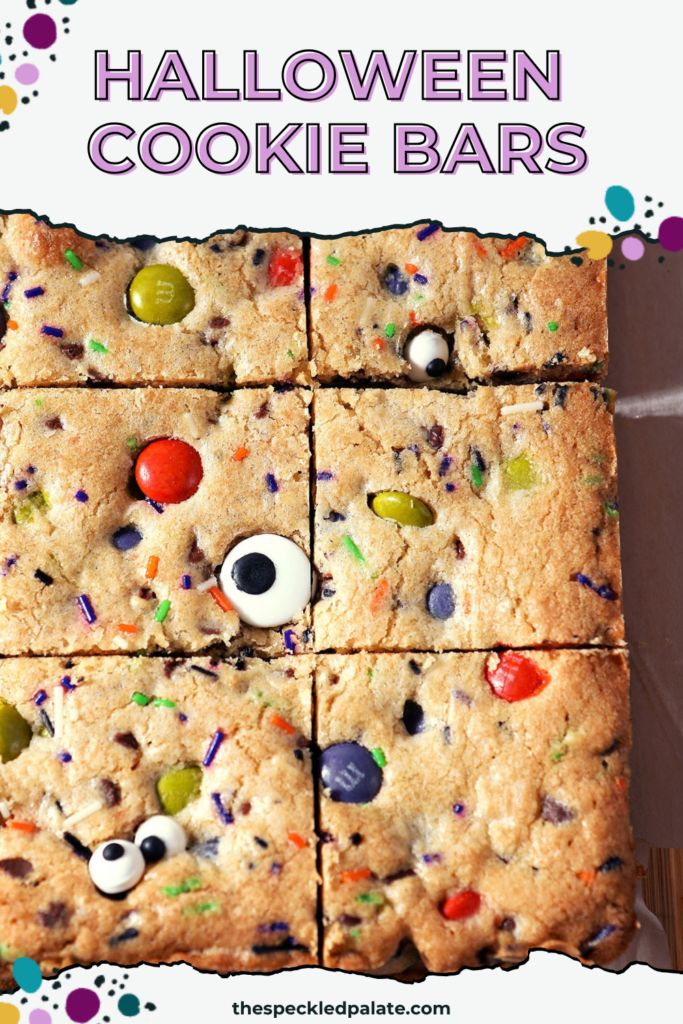 Sliced Halloween Cookie Bars on parchment paper with Pinterest Title, "Halloween Cookie Bars" on top.